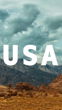 Vertical-Video-Of-Mountains-And-Desert-Landscape-In-American-National-Park-Overlaid-With-Animated-Graphic-Spelling-Out-USA